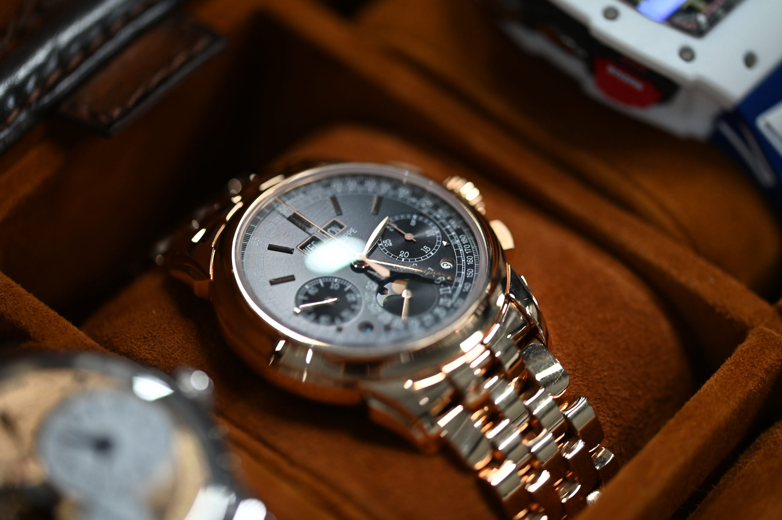 Rose gold Patek Philippe perpetual calendar chronograph resting in a suede watch roll