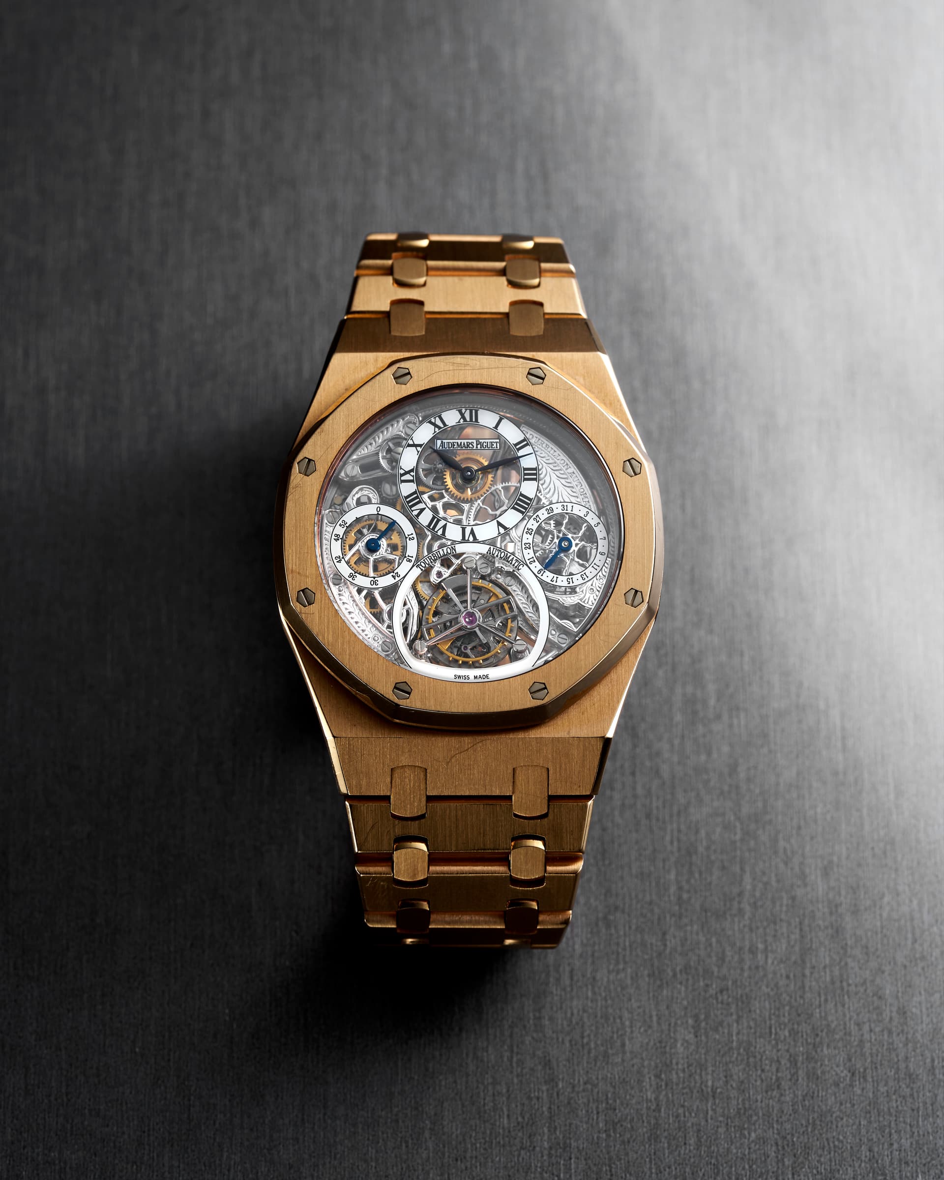 Audemars Piguet Royal Oak Tourbillon Squelette, yellow gold — Three-quarter view: octagonal bezel, openworked movement and integrated yellow gold bracelet.