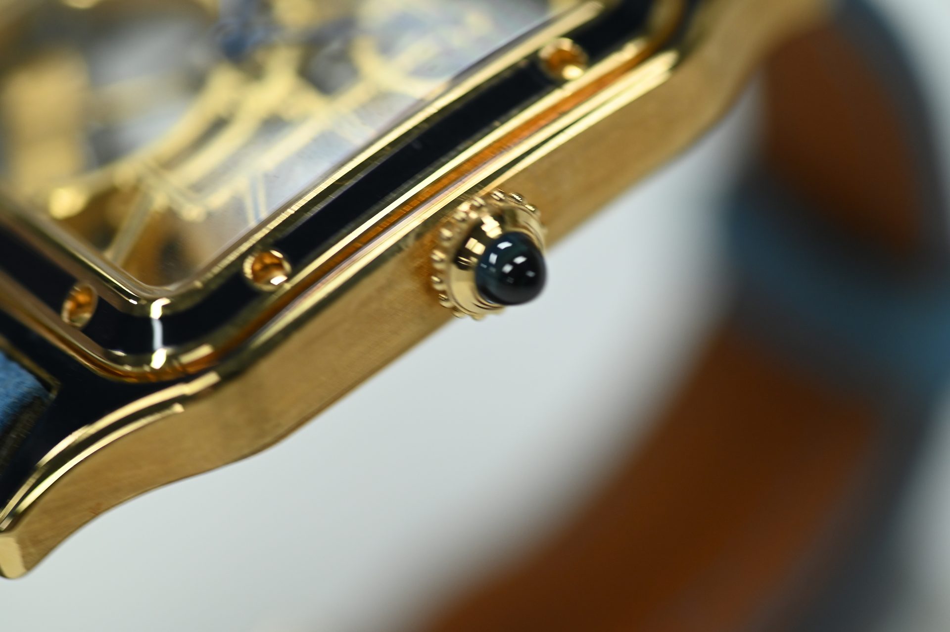 Cartier Santos-Dumont Skeleton — Beaded crown set with its cabochon, flanked by the case screws.