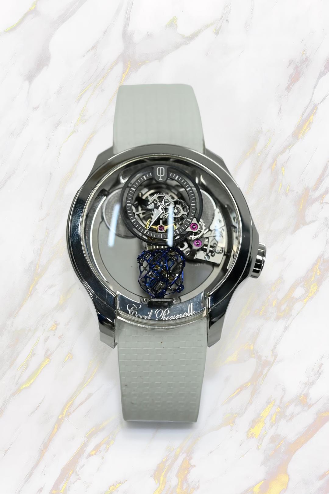 Cecil Purnell tourbillon in white metal, the blued spherical tourbillon cage suspended below a floating hours dial on a white rubber strap