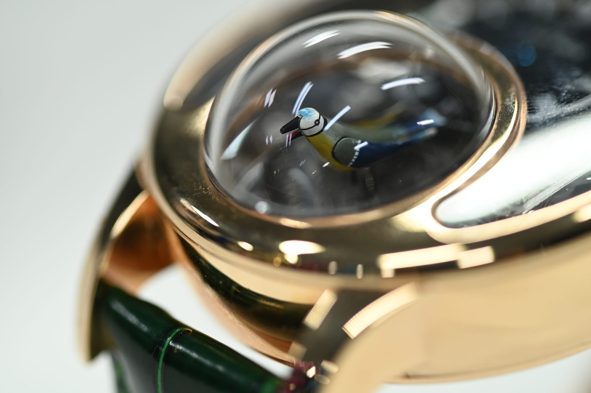 Jaquet Droz Charming Bird — The miniature hand-painted bird beneath its blown sapphire dome.