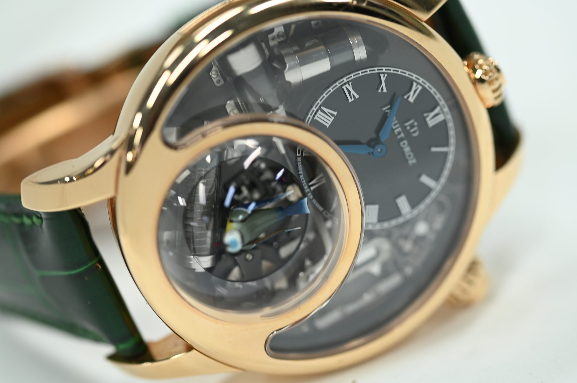 Jaquet Droz Charming Bird — Three-quarter view of the rose gold case and green alligator strap.