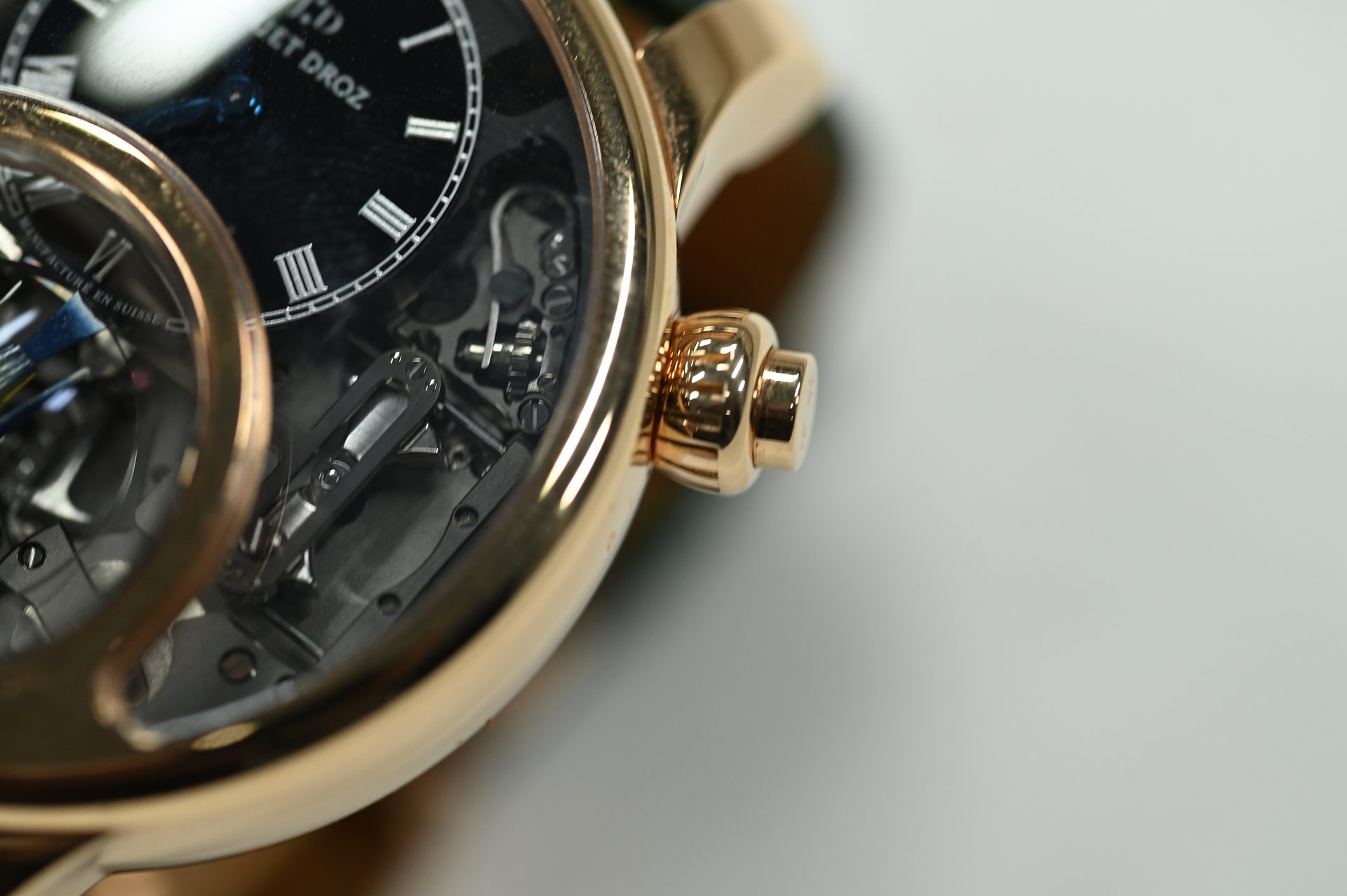 Jaquet Droz Charming Bird — Dial and crown detail with the automaton mechanism visible behind sapphire.