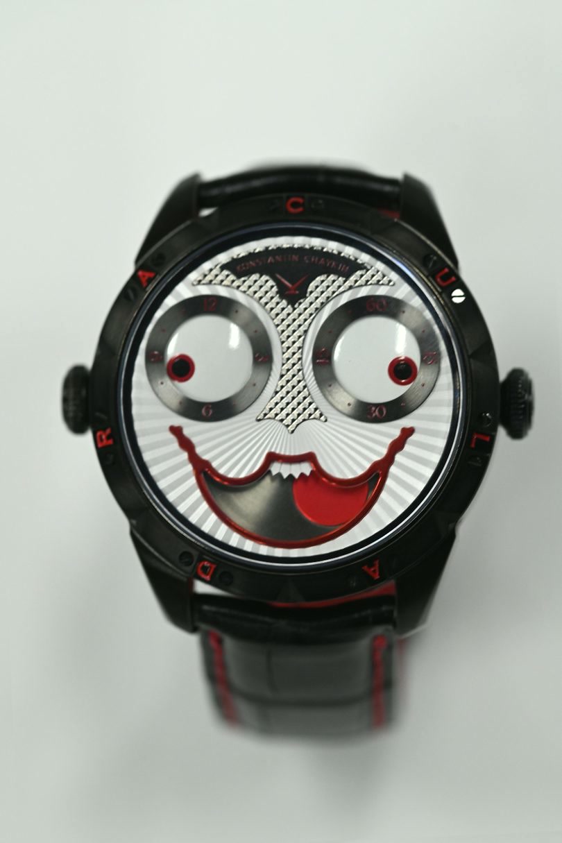 Konstantin Chaykin Joker in blackened steel, the dial reading as a face with regulator eyes and a red lacquer moonphase mouth