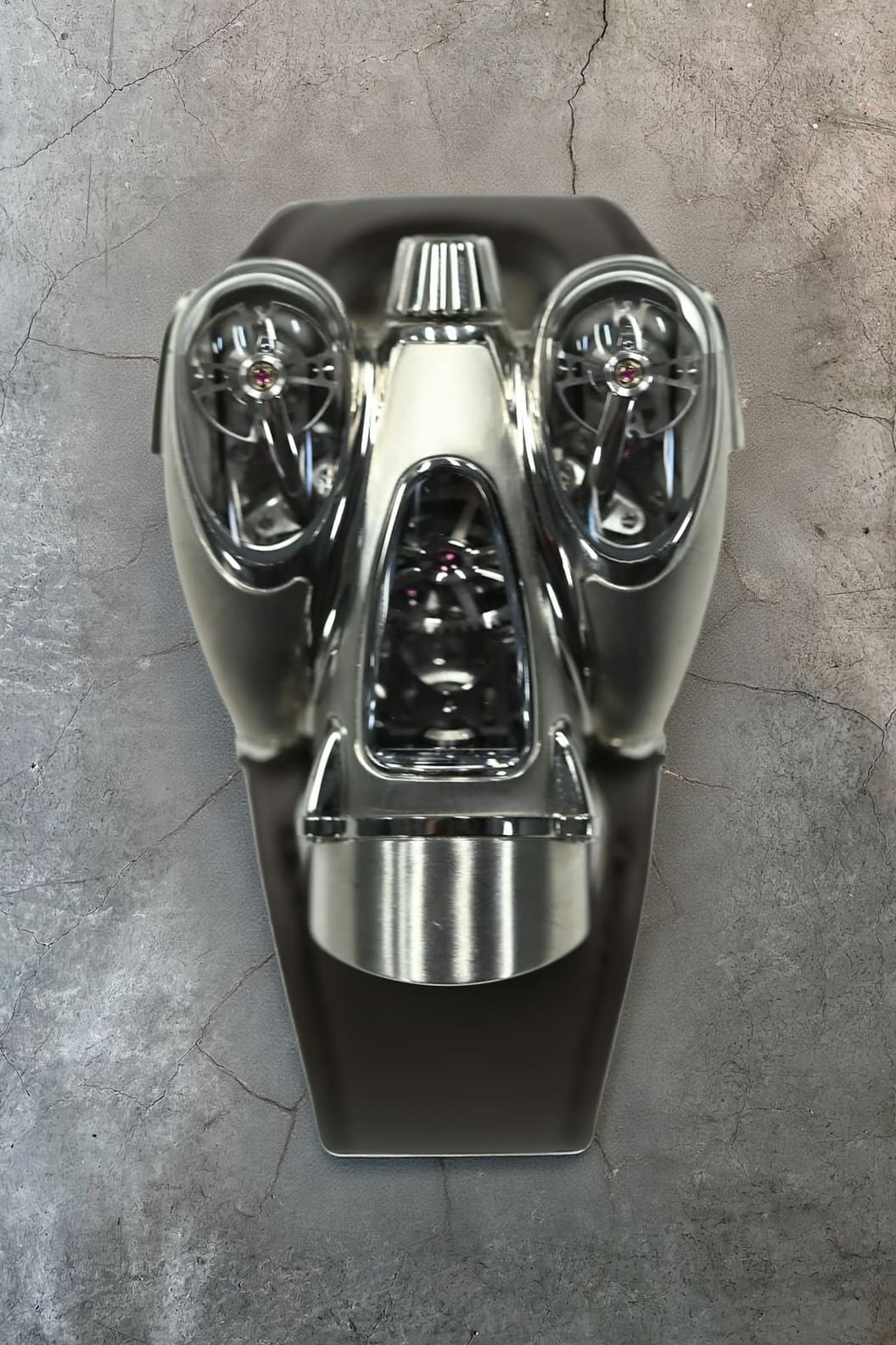 MB and F HM9 Flow in polished titanium with twin lateral pods housing balance wheels and a central planetary differential