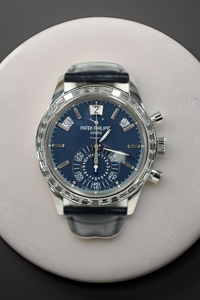 Patek Philippe annual calendar chronograph in white gold with blue dial signed Tiffany and Co, baguette diamond bezel and diamond markers