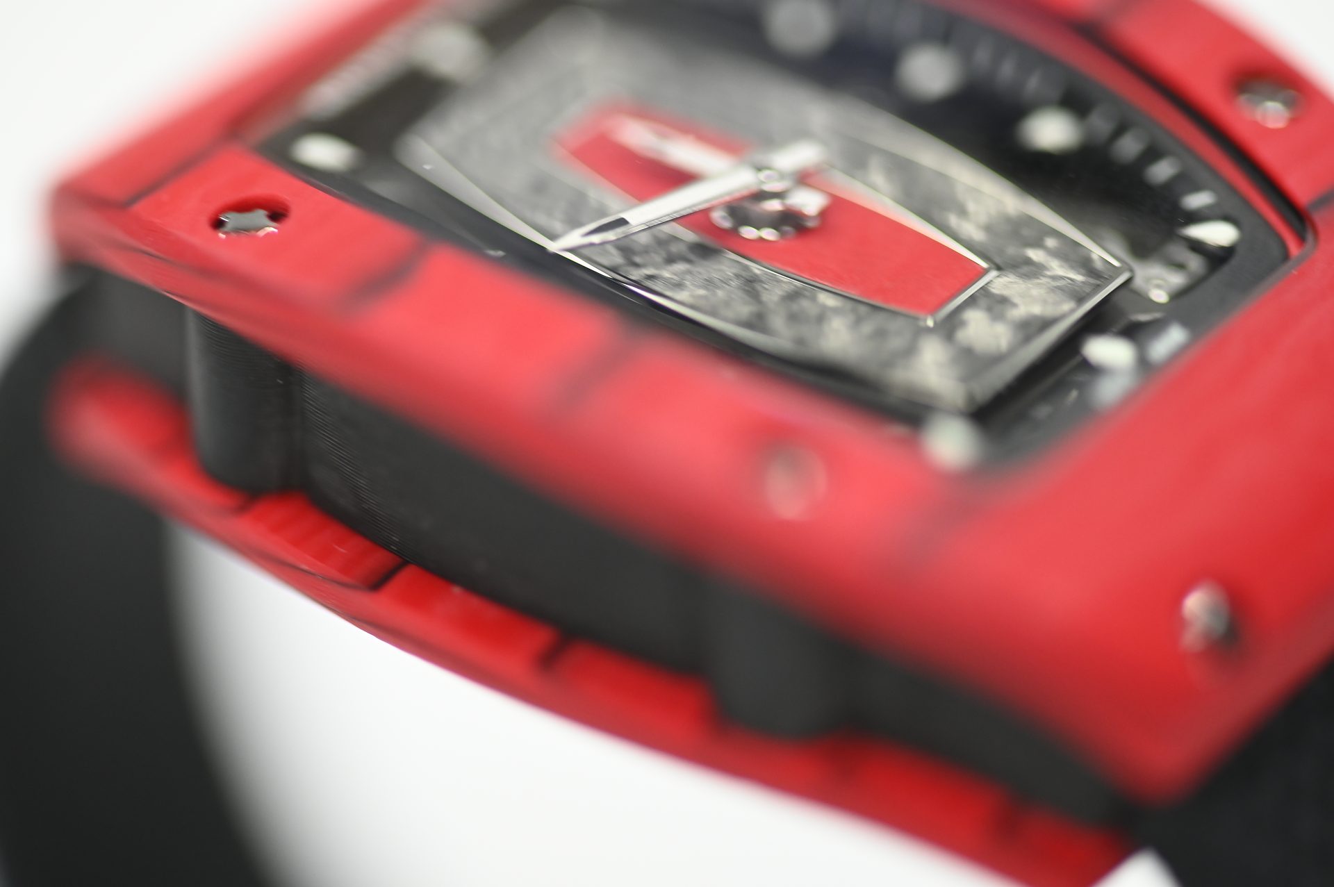 Richard Mille RM 07-01 Red Quartz TPT — Dial detail showing the layered Carbon TPT plate and applied red bridge.