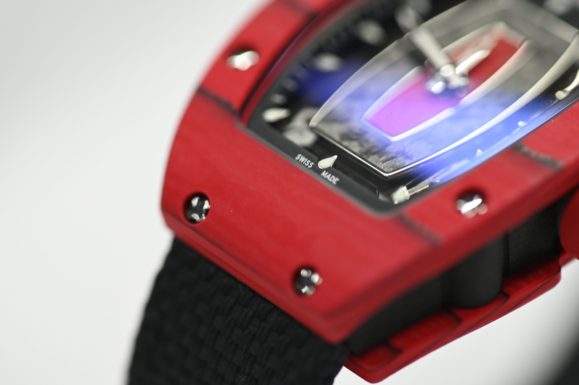 Richard Mille RM 07-01 Red Quartz TPT — Profile view with the Swiss Made marking and moulded rubber strap.