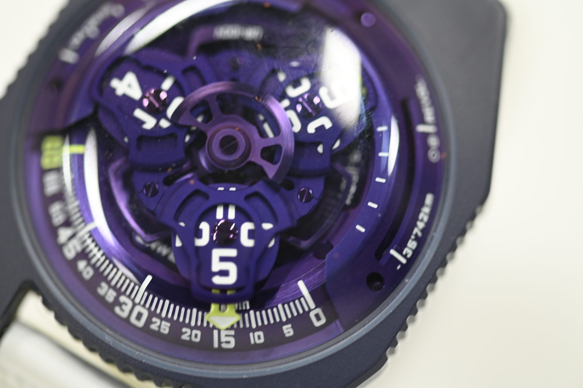 URWERK UR-100V — UR-100V in violet, satellite hour carousel under the arched display.