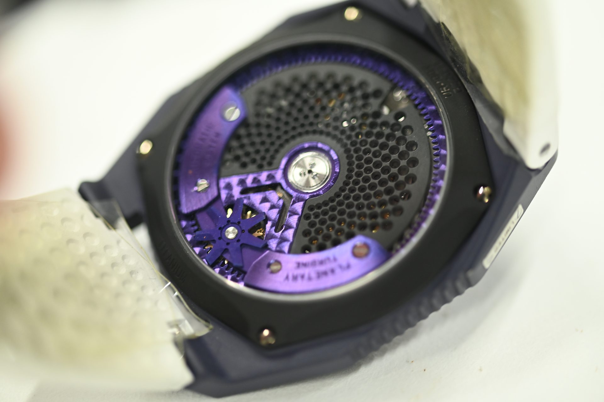 URWERK UR-100V — Caseback with the URWERK engraving and the winding turbine.